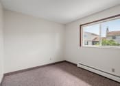 Thumbnail 18 of 57 - a bedroom with a large window and a carpeted floor