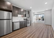 Thumbnail 20 of 45 - a kitchen with stainless steel appliances and wooden floors