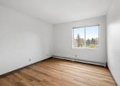 Thumbnail 7 of 25 - the living room of an empty house with wood floors and a window
