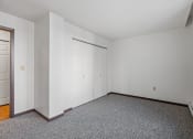 Thumbnail 16 of 51 - a bedroom with white walls and carpet and a white door