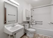 Thumbnail 39 of 51 - a bathroom with a sink toilet and a bath tub