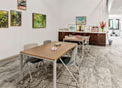 Thumbnail 42 of 55 - a conference room with a table and chairs and paintings on the wall