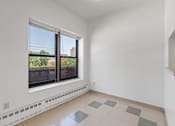Thumbnail 61 of 67 - a living room with a large window and a tiled floor