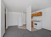 Thumbnail 5 of 51 - an empty kitchen with white appliances and wooden cabinets