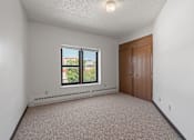 Thumbnail 59 of 67 - an empty bedroom with a window and a closet
