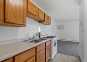 Thumbnail 19 of 51 - a kitchen with white appliances and wooden cabinets