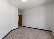 Thumbnail 58 of 67 - an empty room with white walls and a door to a bathroom
