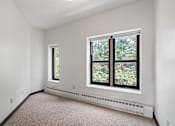 Thumbnail 57 of 67 - room with large windows and carpeting in a white room