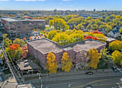 Thumbnail 18 of 27 - an aerial view of a building in a city with trees