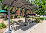 Thumbnail 10 of 55 - a park with benches and awnings on a sidewalk