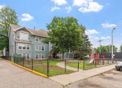 Thumbnail 27 of 31 - the view of a house with a playground in front of it