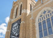 Thumbnail 29 of 45 - the side of a church with a steeple and a stained glass window