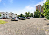 Thumbnail 49 of 67 - a parking lot with cars parked in front of a building