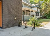 Thumbnail 40 of 52 - the front of a brick house with a sidewalk and bike racks