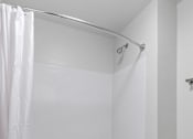 Thumbnail 15 of 53 - a white bathroom with a shower and a toilet