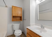 Thumbnail 55 of 67 - a bathroom with a toilet and a sink and a mirror