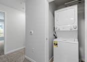 Thumbnail 12 of 53 - a white washer and dryer in a room next to a door