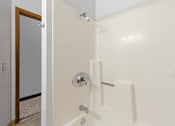 Thumbnail 54 of 67 - a white bathroom with a shower and a door