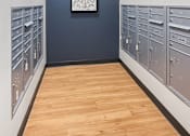 Thumbnail 17 of 22 - A long hallway with a row of mailboxes on the left and a row of mailboxes on the right.