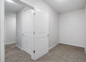 Thumbnail 11 of 53 - a bedroom with two closets and a carpeted floor