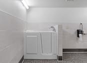 Thumbnail 49 of 55 - a bathroom with a washer and dryer in it