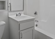 Thumbnail 40 of 51 - a white bathroom with a sink and a mirror