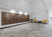 Thumbnail 33 of 55 - a large locker room in a building with yellow chairs