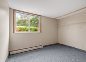Thumbnail 5 of 57 - an empty room with a window and clothes racks