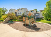Thumbnail 51 of 57 - a playground with a table and chairs in front of some apartments