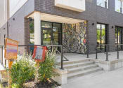 Thumbnail 39 of 52 - the front of a building with stairs and a glass door