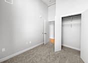 Thumbnail 16 of 24 - an empty bedroom with a closet and a door to the bathroom
