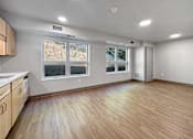 Thumbnail 15 of 22 - the living room and kitchen of an empty house with a large window