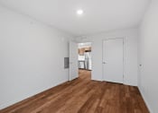 Thumbnail 21 of 36 - a living room with white walls and wood floors