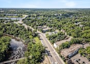 Thumbnail 23 of 23 - an aerial view of a city with a highway and a river