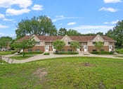Thumbnail 2 of 43 - a group of houses in a neighborhood with green grass and trees