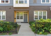 Thumbnail 31 of 52 - the front of a brick house with a sidewalk in front