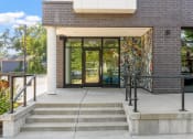 Thumbnail 37 of 52 - the entrance of a building with glass doors and a mural on the side