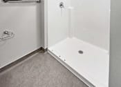 Thumbnail 13 of 22 - a white shower with a sliding glass door in a bathroom