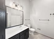 Thumbnail 8 of 24 - a bathroom with a sink and a toilet and a mirror