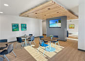 Thumbnail 1 of 22 - A conference room with a TV screen and chairs.