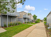 Thumbnail 12 of 40 - a sidewalk in front of a row of houses