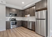 Thumbnail 3 of 45 - a kitchen with stainless steel appliances and wooden cabinets