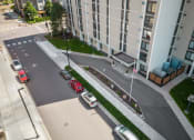 Thumbnail 23 of 51 - an aerial view of a street with cars parked in front of an apartment building