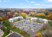 Thumbnail 23 of 25 - an aerial view of a parking lot and apartment buildings