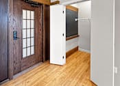Thumbnail 1 of 24 - a renovated living room with a wooden door and a white closet