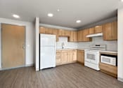 Thumbnail 3 of 22 - a kitchen with white appliances and wooden cabinets