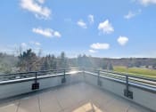 Thumbnail 13 of 36 - the view from the balcony of a building overlooking a field and trees