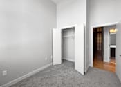 Thumbnail 17 of 24 - an empty room with white walls and a closet in it