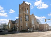 Thumbnail 21 of 45 - an old church with a clock tower on the side of a street