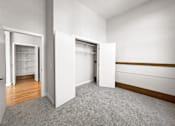 Thumbnail 7 of 24 - an empty room with white walls and doors to closets
